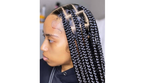 femme portant la coiffure afro knotless braids par Saison des Pluies marque de produits capillaires naturels.