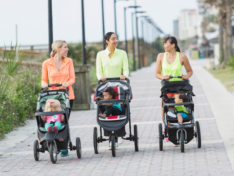 Three women walking with strollers