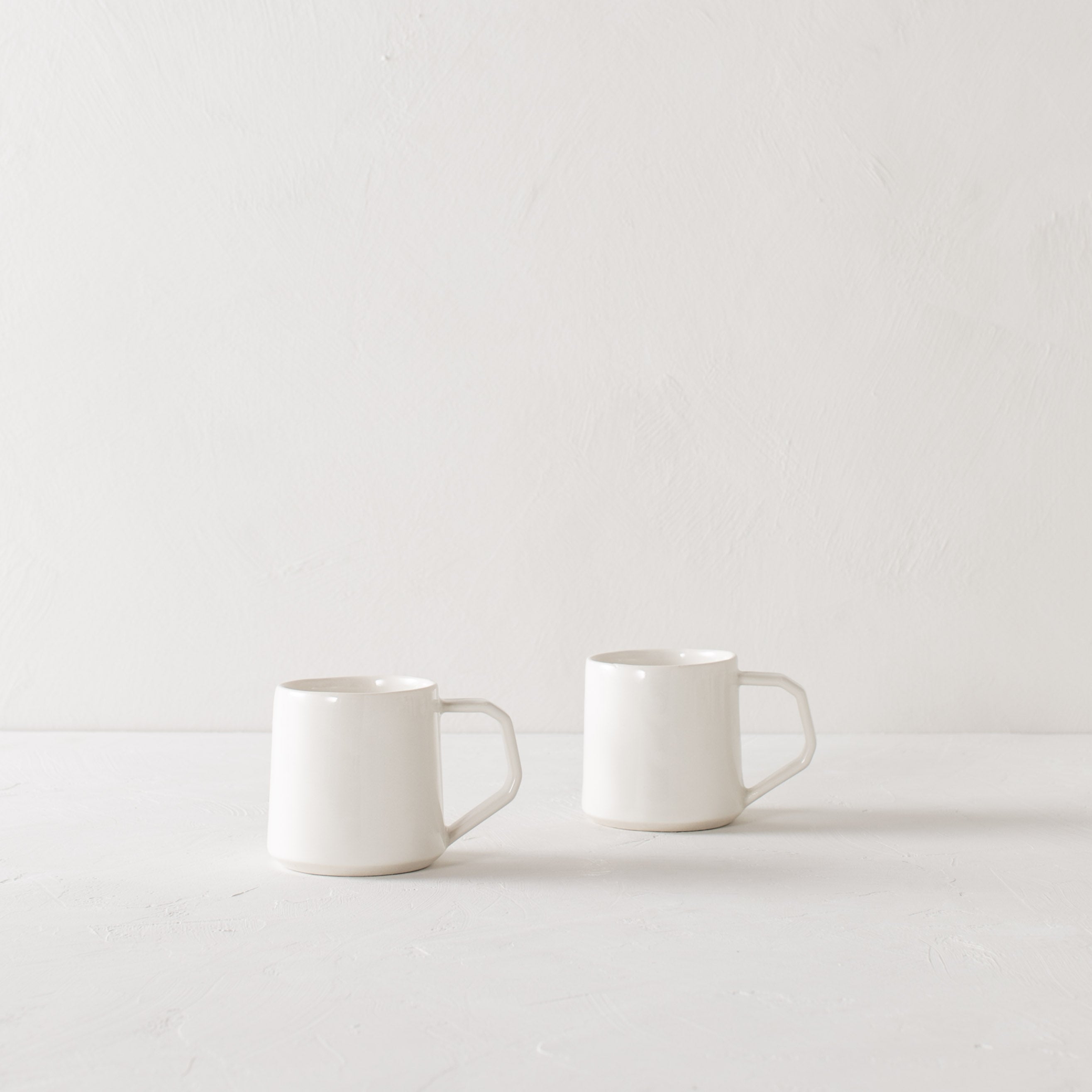 white pottery mugs