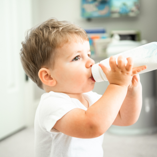 Baby boy drinking from a bottle