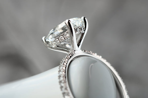 Lab-grown diamond engagement ring with hidden halo and diamond shoulder accents
