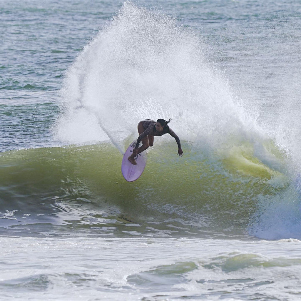Ellie Brooks surfing a wave