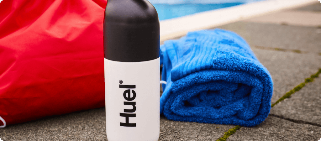 huel with towel by a swimming pool