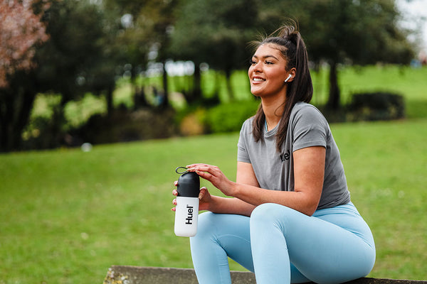 Woman drinking Huel while working out