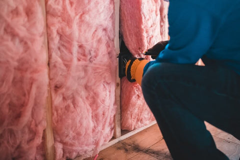 a house being fitted with pink insulation material