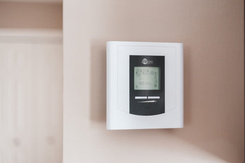 a thermostat on a wall with temperature shown