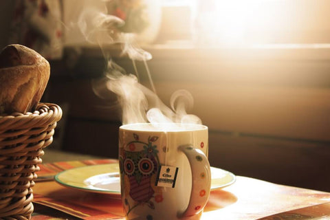 a steaming hot drink in a patterned mug