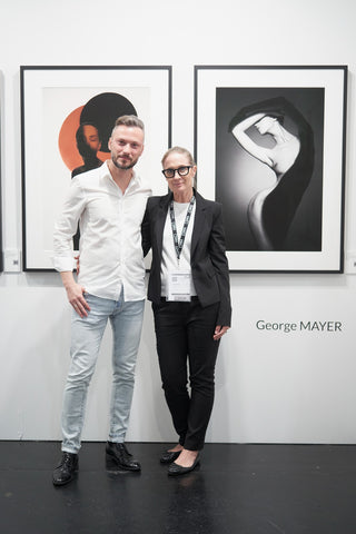 George Mayer and LIGHTWORKS Founder Dina Meier in front of 2 artworks by the artist at MIA Photo Fair 2023