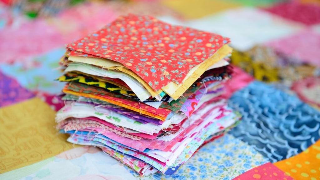 A stack of quilting blocks ready to be sewed together. 