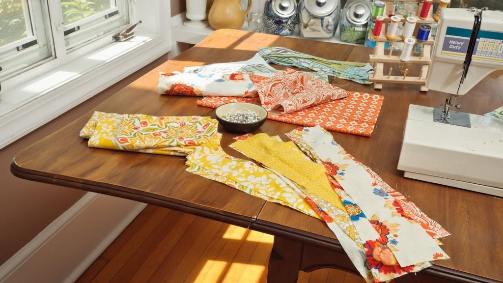 How to start quilting: a table full of fabric and quilting equipment. 