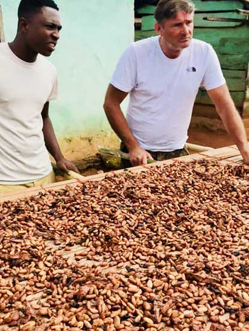 Simon Dunn with drying cocoa beans