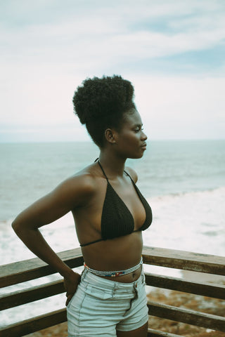 Woman wearing waist beads on the beach