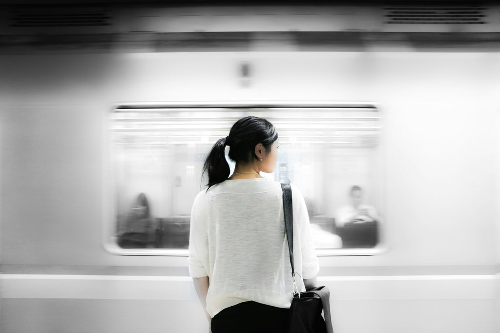 Asian Girl in White Shirt Riding Subway Being Cautious of Dangers