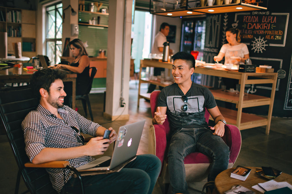 Two Tech Bros Working While Socializing