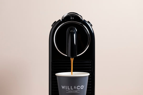 A coffee being poured from a pod machine