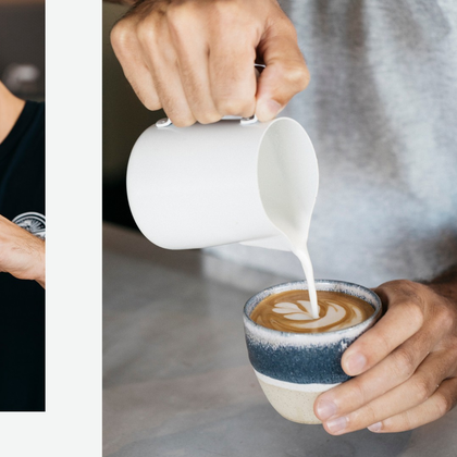 A barista pouring warm milk into a cup of coffee