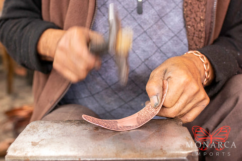 Copper artisan working on a copper bracelet