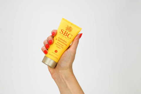 Hand holding Calendula & Macadamia Hand & Foot Cream