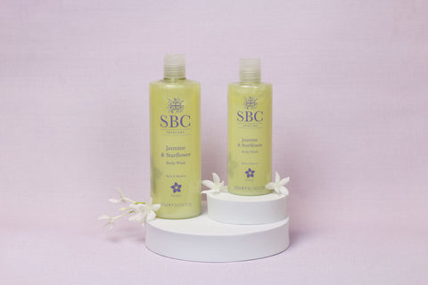 Jasmine & Starflower Body wash on a purple background with white flowers