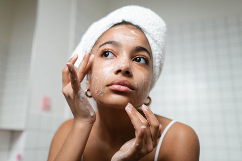 Woman washing her face in bathroom