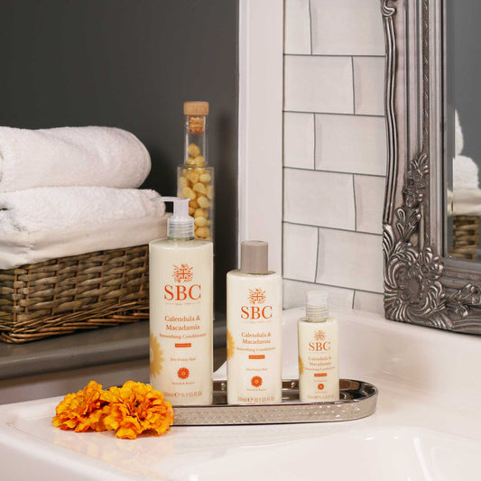 SBC Skincare's Calendula & Macadamia Conditioner 500ml, 300ml and 100ml on a bathroom sink