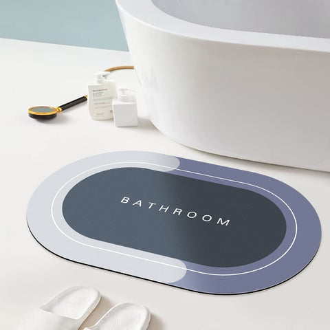 A Matace oval Bathroom Floor Mat is laid out in front of a white bathtub.