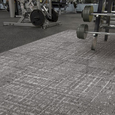 In a dark-colored gym, Matace gray carpet squares cover the floor.
