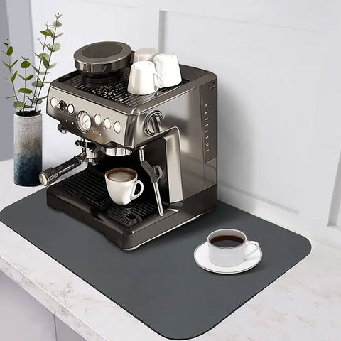 In a minimalist coffee bar, a Matace coffee pot mat for countertops is lined with gray coffee machines.