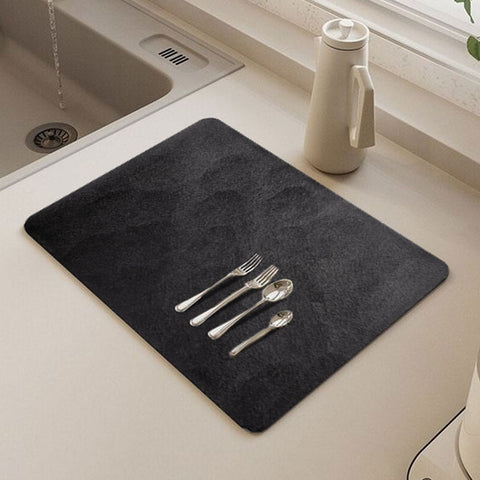 Some forks resting on matace dish drying mats in an Instagram-style kitchen.