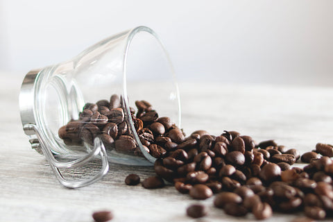 coffee mug with beans spilling out