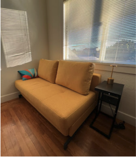 brown sofa infront of a window