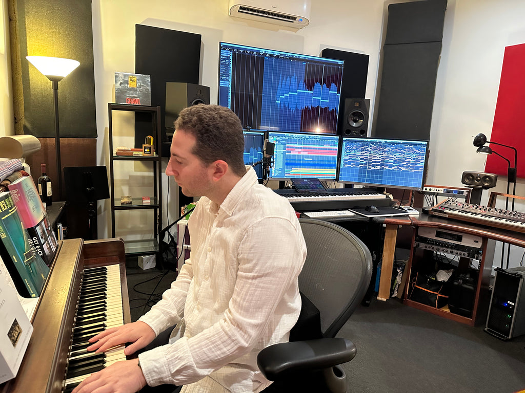 Max Aruj playing piano in his studio