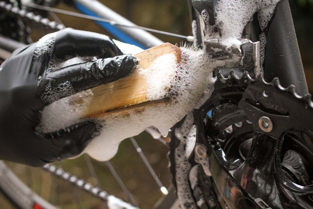 Cleaning bicycle chain with manual mountain biking brush, gravel or road