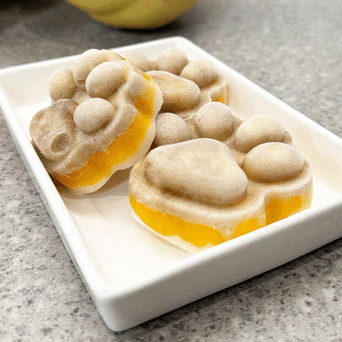 Candy corn ice pops in a white dish.