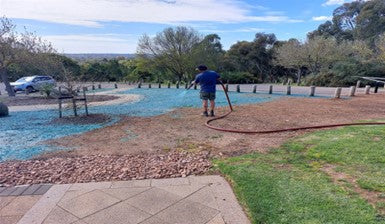 A man hydroseeding wildflower seeds