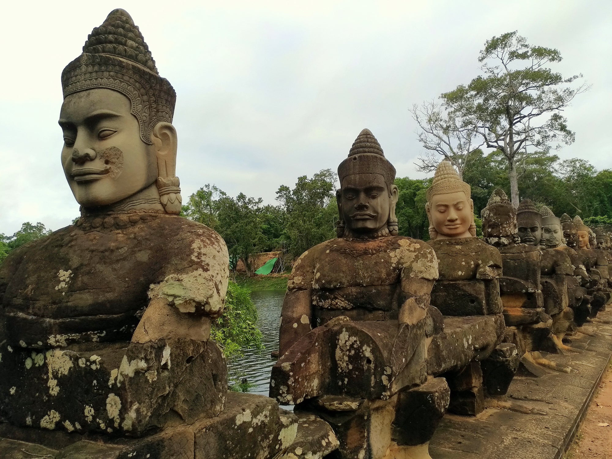 Angkor Thom - Churning of the Ocean Hindu mythology scene featuring rows of Gods and Demons on the causeway leading to Bayon