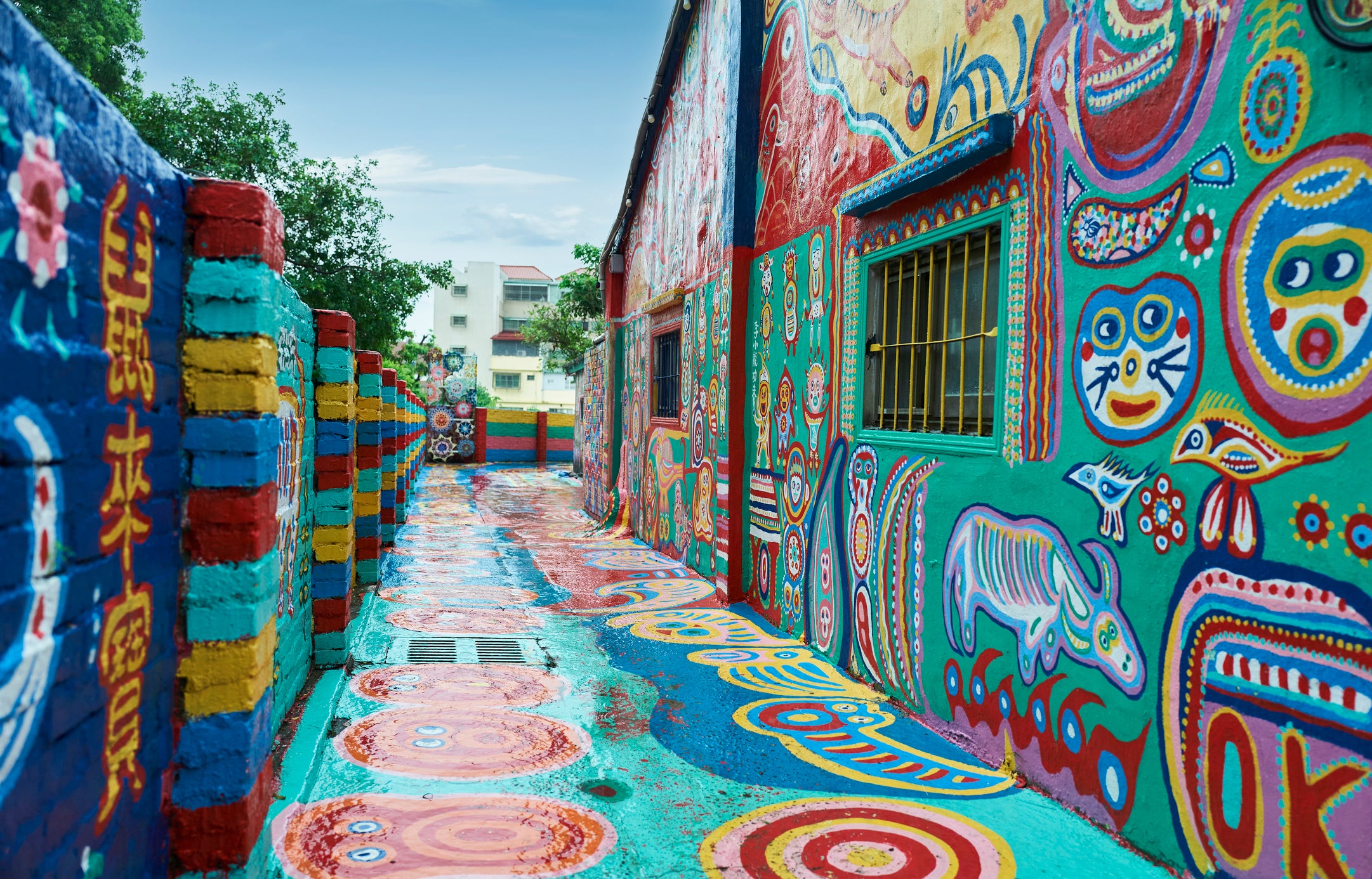 The colourful chinese graffiti painted on the wall at Rainbow Village