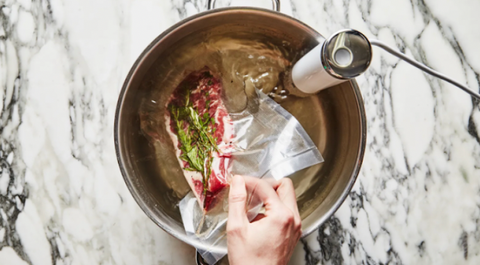 Steak vacuumed sealed, in a pot and ready to sous vide