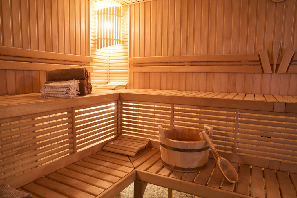 Wooden-sauna-with-soft-light-and-sauna-equipment-and-wooden-sauna-benches