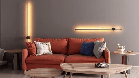 Two Nordic Stick Lights on the wall above red sofa