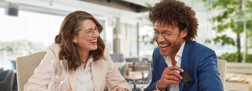 Man and woman at a restaurant wearing ThinOptics Vision Solutions
