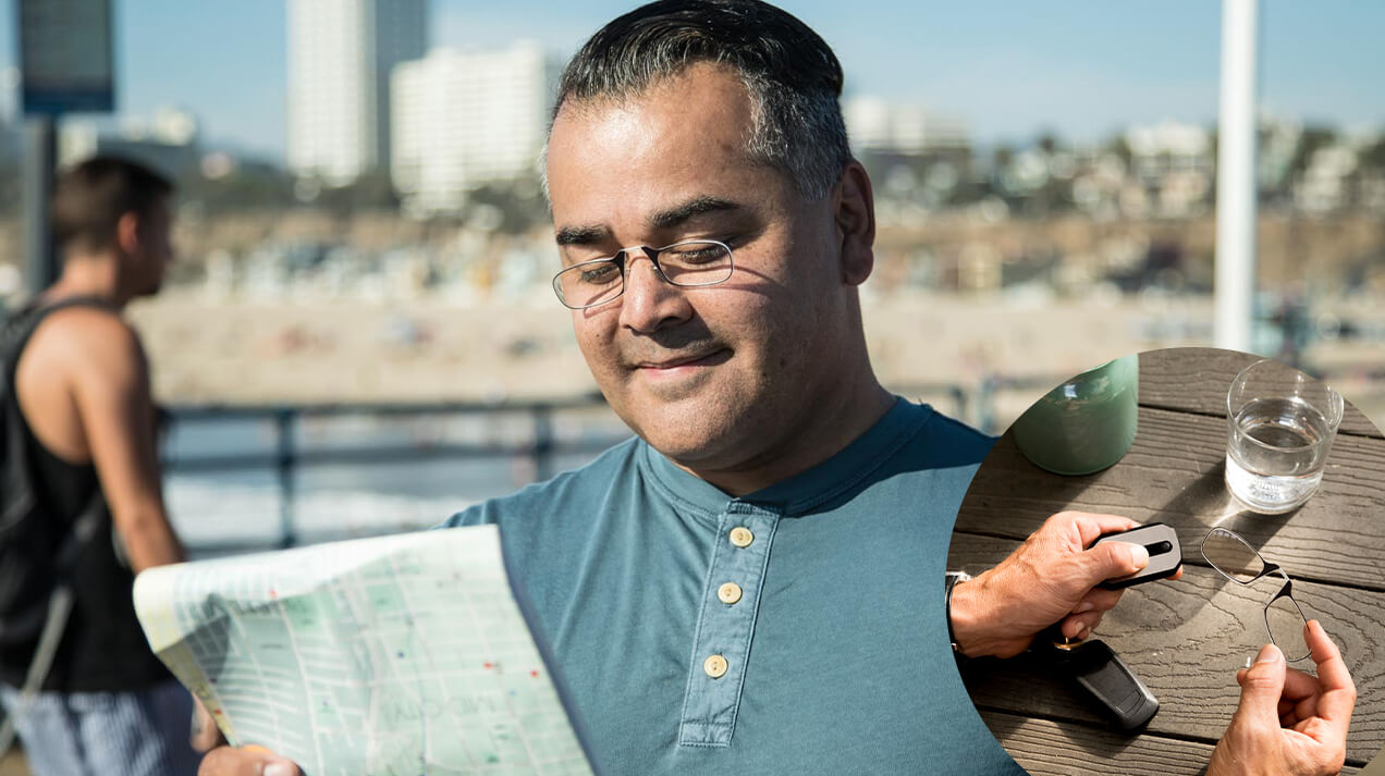 Man wearing Readers while looking at a map