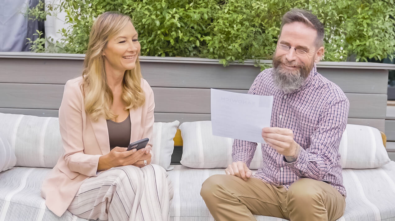 Woman sharing her Readers with a man so he can read a restaurant email