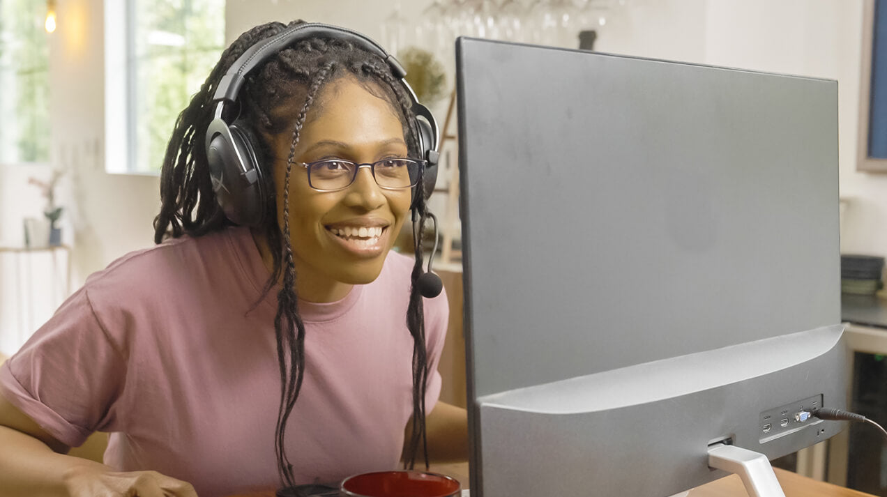 Woman wearing Brooklyn Blue Light Blocking Glasses while playing a game on her computer