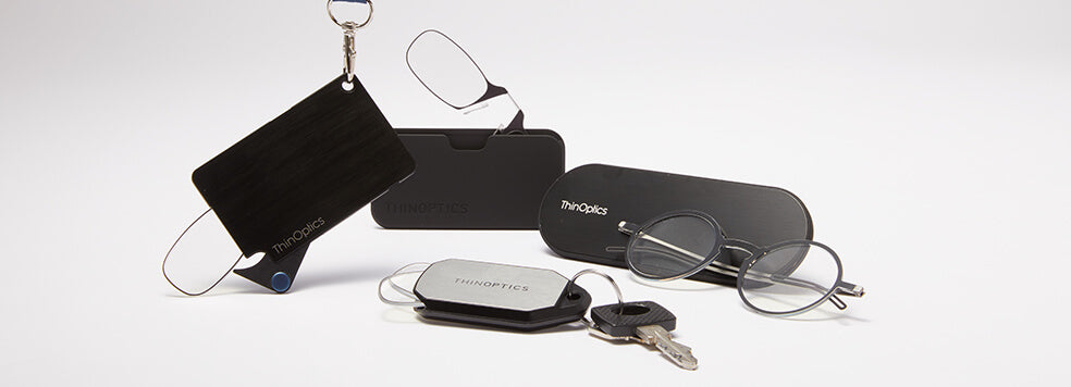 Collection of ThinOptics Vision Solutions including the Readers + Keychain Case, Readers + Universal Pod, and the Manhattan Reading Glasses + Milano Case