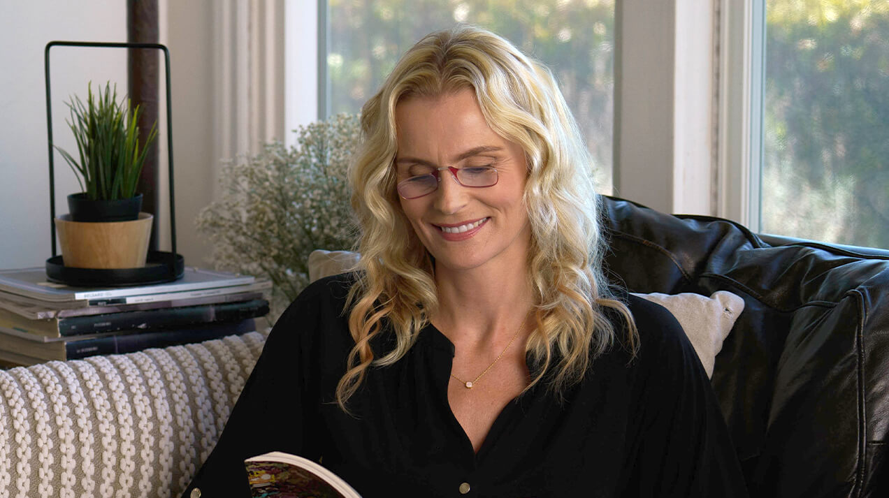 Woman wearing Readers while reading a book