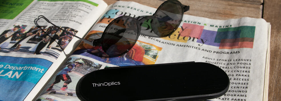 Manhattan Reading Sunglasses with the Milano Case on top of a newspaper