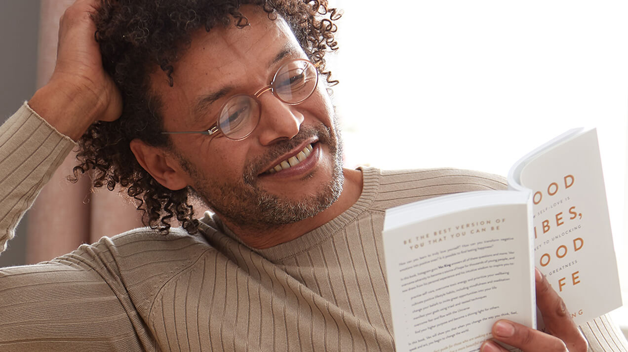 Man wearing Manhattan Reading Glasses while reading a book