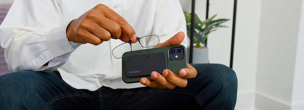 Man removing Readers from a Universal Pod attached to the back of a phone case