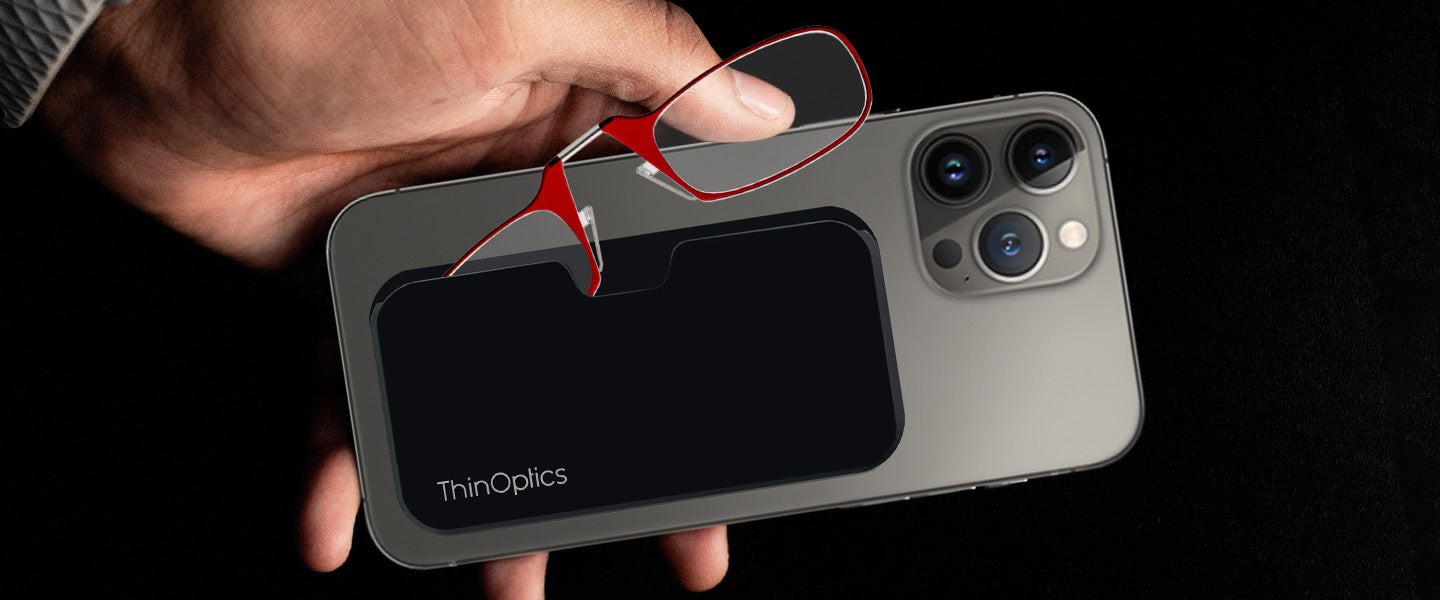 ThinOptics Universal Pod with Headline Readers attached to iPhone 14 Pro Max